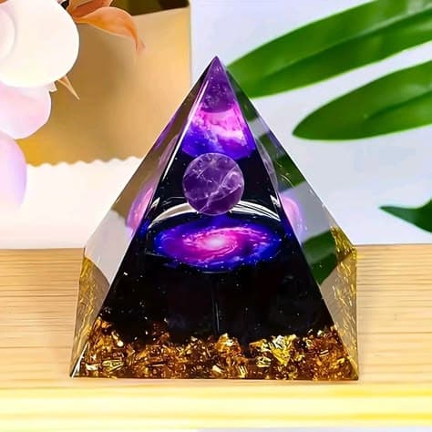 Resin pyramid with a purple galaxy sphere and gold flakes inside